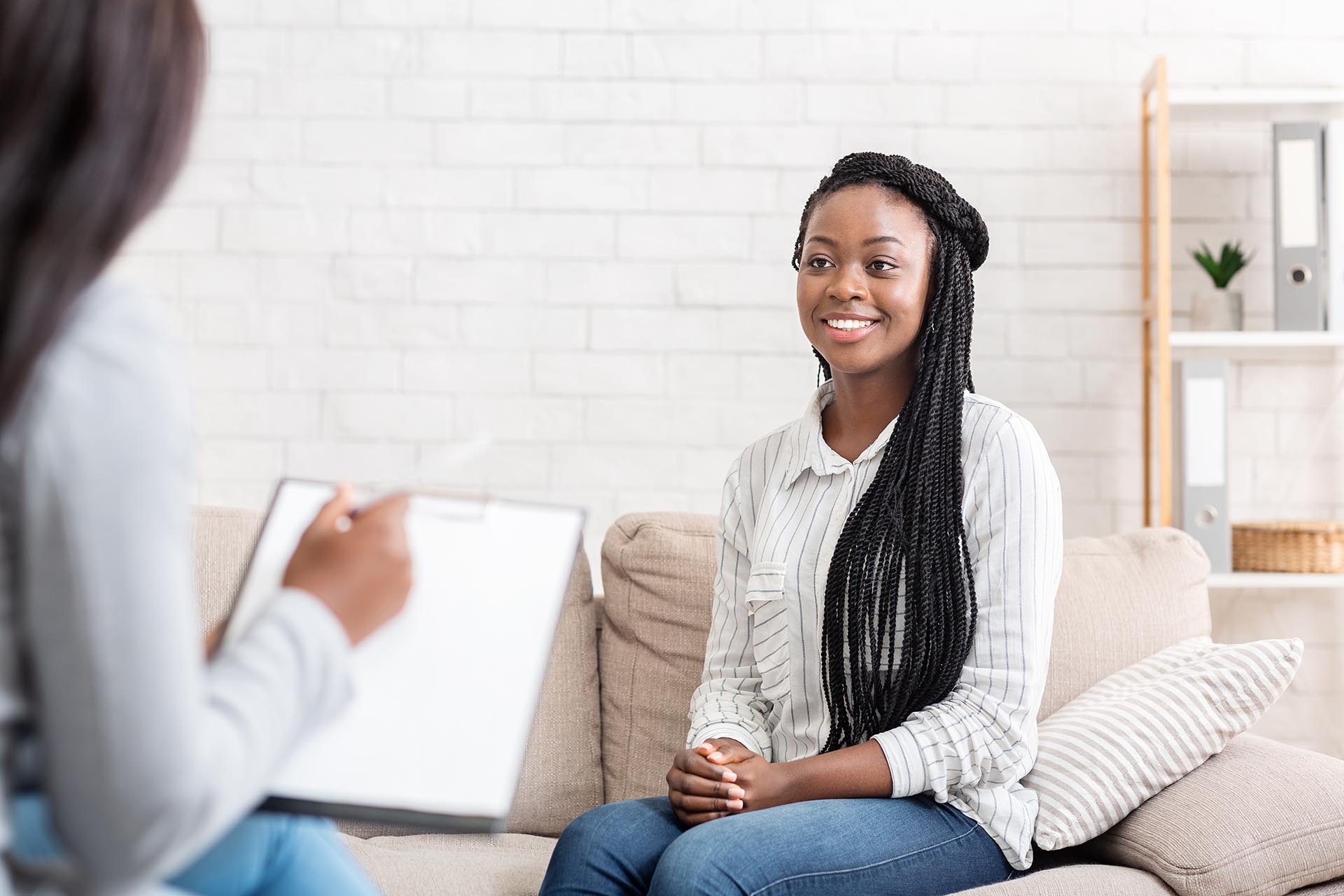 Smiling young woman with braids in a supportive conversation